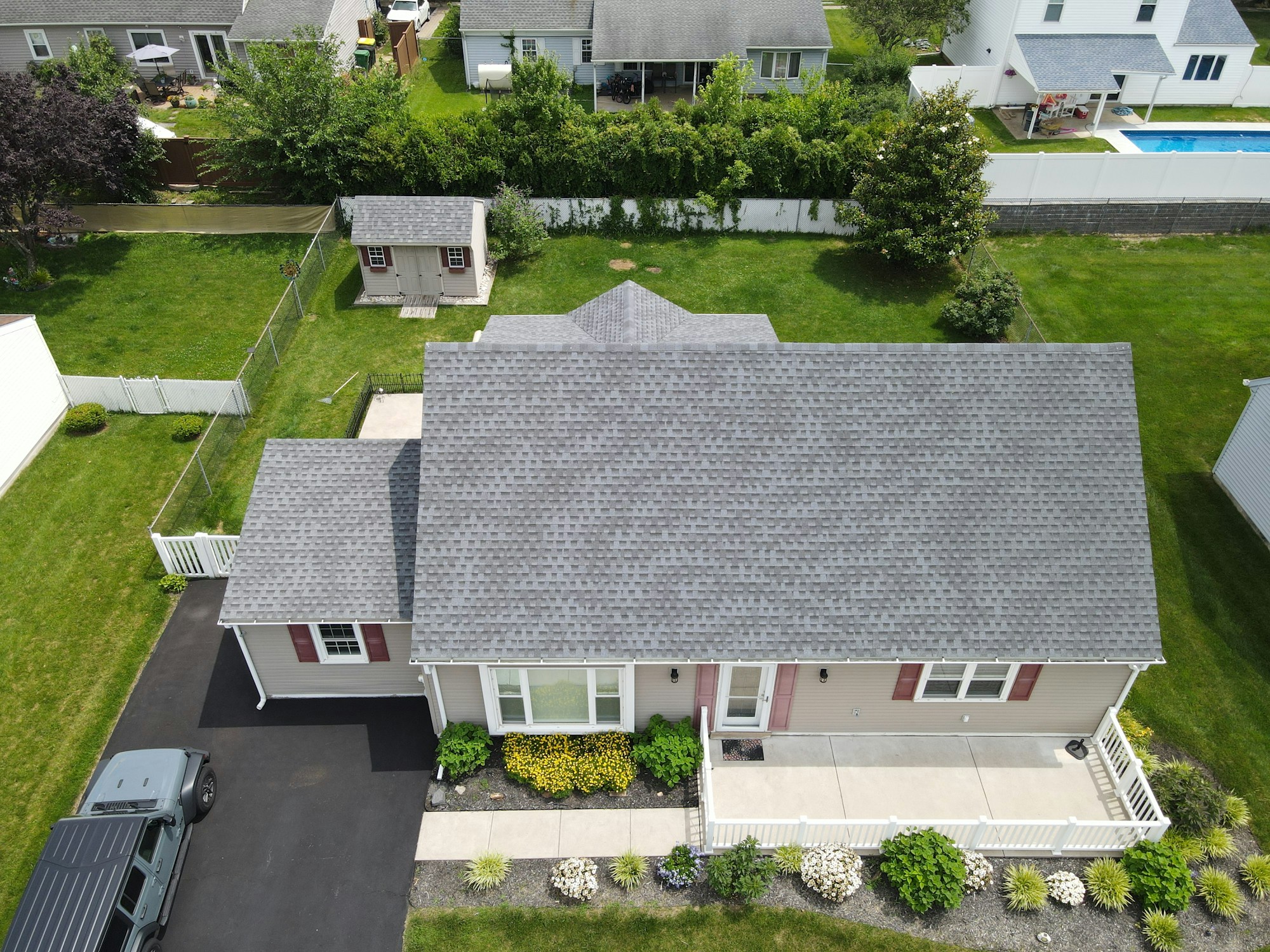 Aerial view of a home with a gray asphalt shingle roof
